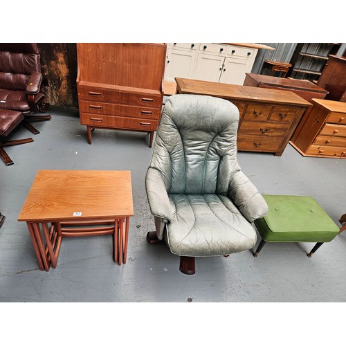 117 - A teak nest of tables, footstool and a leatherette swivel armchair