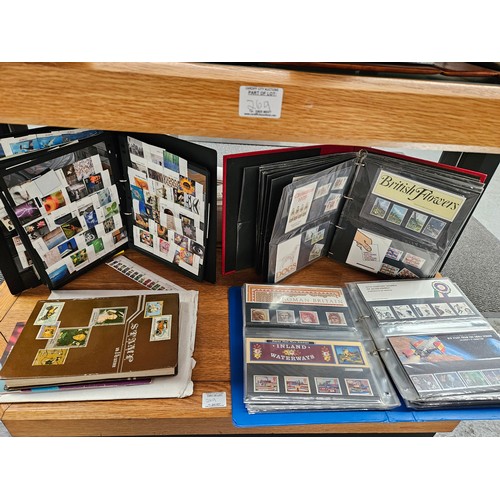 269 - A collection of mint British stamps in albums and collectors sets - displayed over three shelves