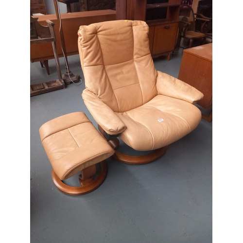 417 - A leatherette swivel armchair and matching footstool