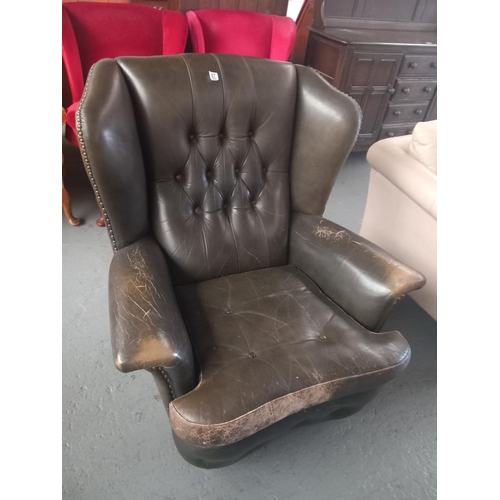 427 - A green leather Chesterfield style wingback armchair