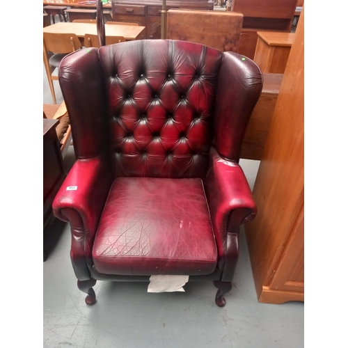 453 - A red leather Chesterfield armchair