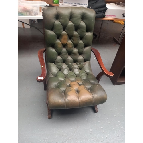 466 - A green leather Chesterfield style armchair