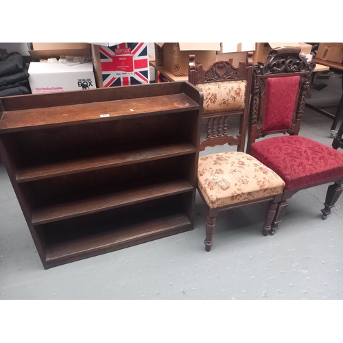 467 - An oak bookcase and two hall chairs