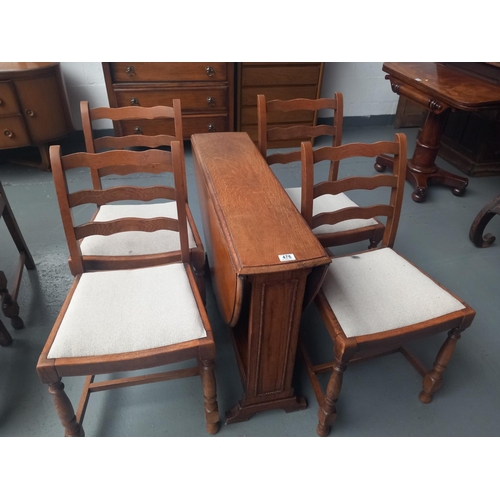 476 - An oak drop leaf dining table and four chairs