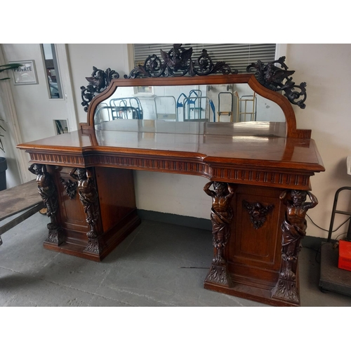 495 - A very large mahogany mirrored back buffet with carved top and two cupboard with carved male support... 