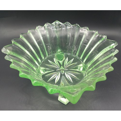 500 - A large uranium glass dessert bowl (10 inch diameter) with four matching smaller bowls together with... 