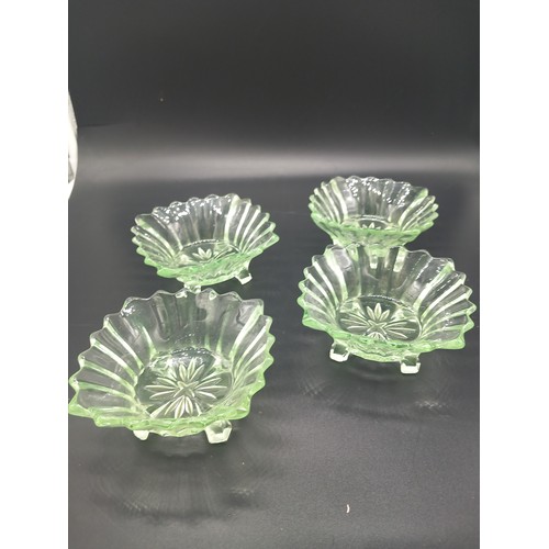 500 - A large uranium glass dessert bowl (10 inch diameter) with four matching smaller bowls together with... 