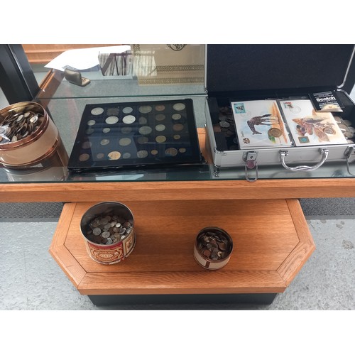 518 - A selection of world coins displayed over two shelves