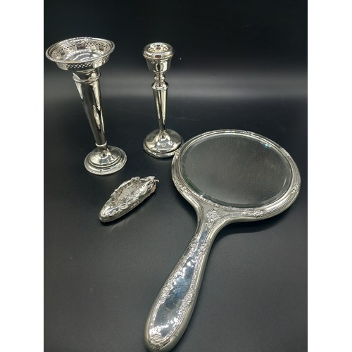 774 - A weighted silver vase, candlestick and mirror