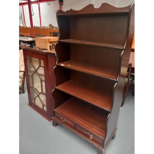 614 - A mahogany waterfall bookcase and a corner cabinet