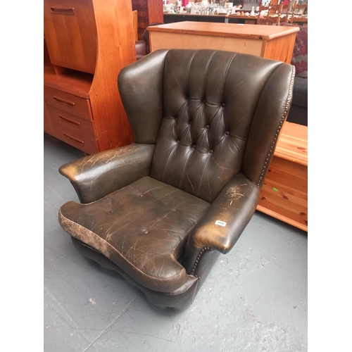 666 - A green leather Chesterfield style armchair