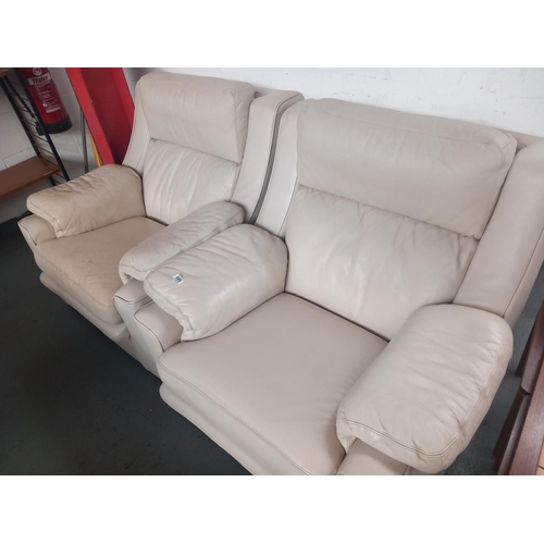 689 - Two cream leather armchairs