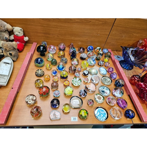 380 - A large collection of paperweights including Murano, Caithness and Mdina