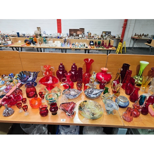 381 - A large group of coloured glassware to include Empoli, Whitefriars and Mdina