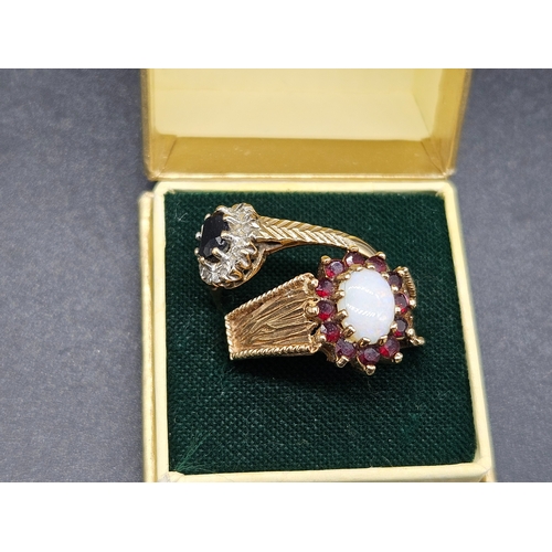 567 - Two 9k gold ladies dress rings - one being opal and garnet and the other with a dark central stone -... 