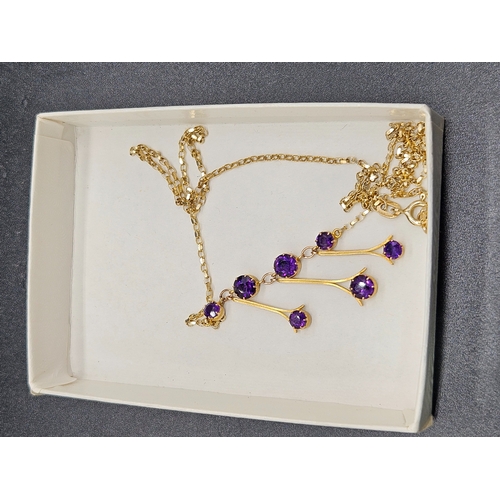 570 - A 9k gold necklace with 7 small purple stones - weight 3.3 grams