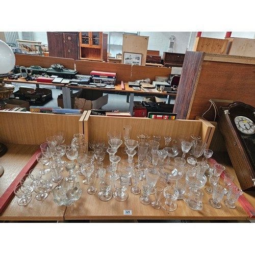 320 - A large group of Victorian and Edwardian drinking glasses to include Rummers and custard cups