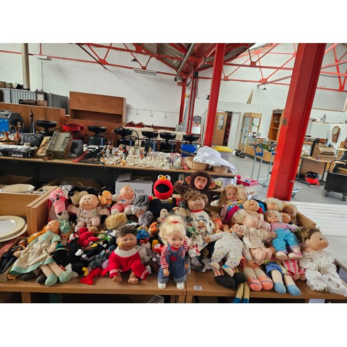 333 - A quantity of vintage dolls and soft toys to include Cabbage Patch, Mickey Mouse, Pink Panther, Womb... 