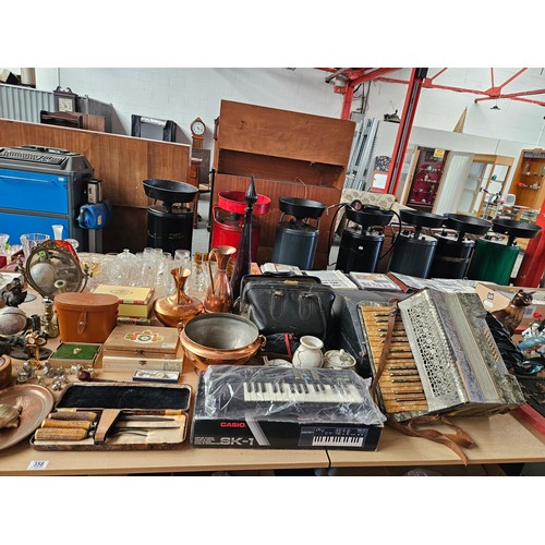 358 - A large quantity of metalware and vintage items to include an accordion, vintage ice skates, copperw... 