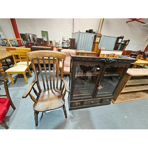 421 - An oak carved display cabinet with adjustable shelves and 3 drawers together with an oak armchair

D... 