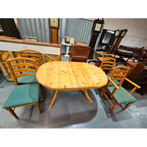 435 - A pine extending dining table with 4 chairs to include 2 carvers