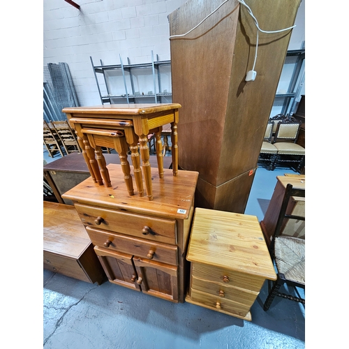 443 - A pine bedside cabinet, nest of tables and a pine cabinet