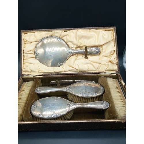 513 - A boxed hallmarked silver dressing table set - mirror and brushes