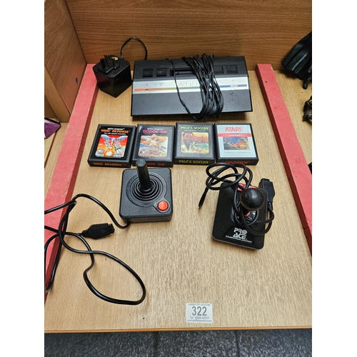 322 - An Atari 2600 games console with 4 games and joysticks