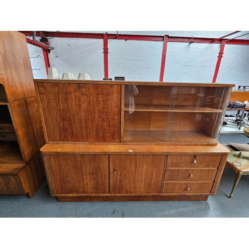 415 - A maple Art Deco style display cabinet

Height 140cm, Width 202cm, Depth 50cm