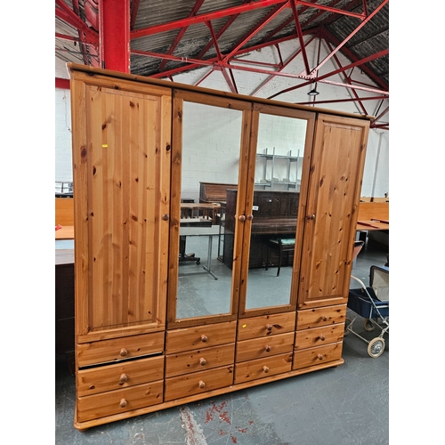 421 - A three sectioned quadruple pine wardrobe/bedroom compactum

Width 196cm, Depth 56cm, Height 200cm