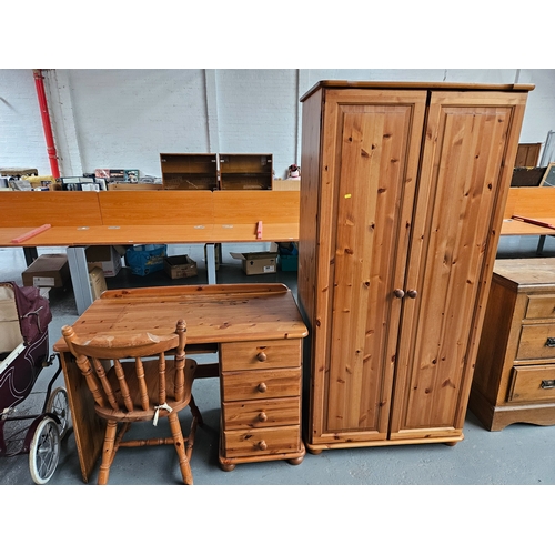 423 - A pine single pedestal desk with chair, and a pine double wardrobe 

Wardrobe measures: Width 84cm, ... 