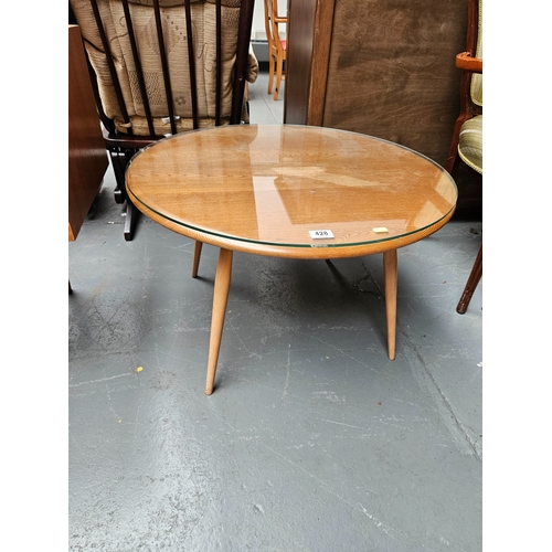 428 - An Ercol circular coffee table with glass top