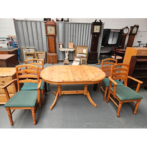 438 - A pine extending dining table with 4 chairs to include 2 carvers