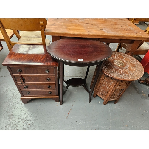 452 - A small mahogany chest of drawers, side table and a carved tourist table