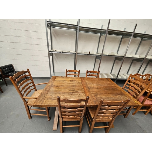 469 - A hardwood extending dining table with 6 oak ladderback chairs