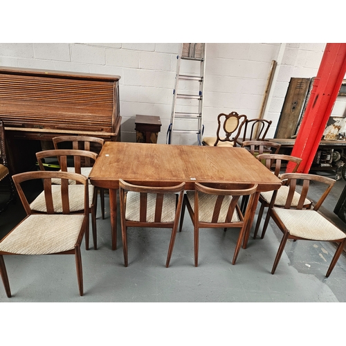 472 - A teak extending dining table with 8 chairs