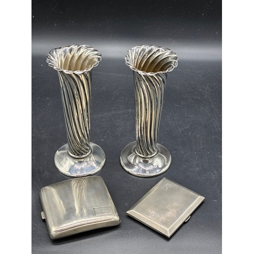 500 - Two silver cigarette cases and a pair of silver vases (damage to the rims) - combined silver weight ... 