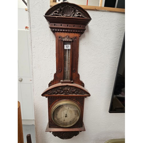 521 - A carved wall hanging barometer untested