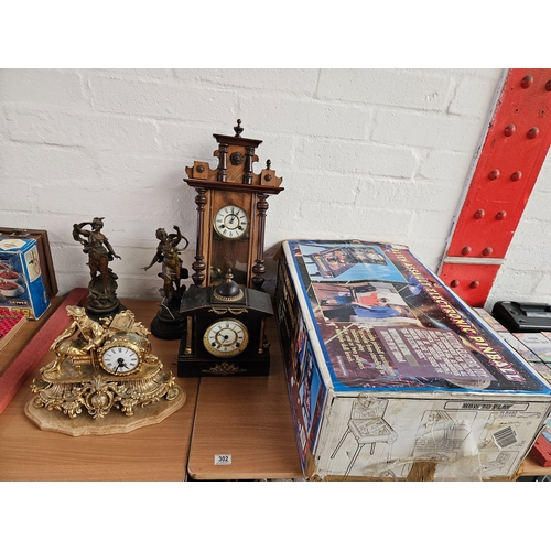 302 - 2 Spelter figures on bases, a slate mantle clock and a brass mantle clock, Vienna wall clock and a b... 