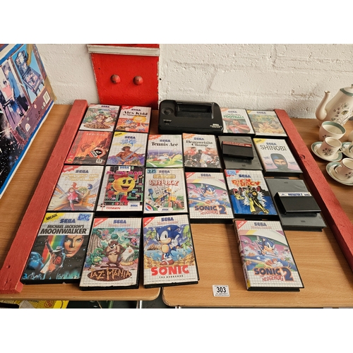 303 - A Sega Master System II console (no leads or controllers) with a selection of Sega games to include ... 