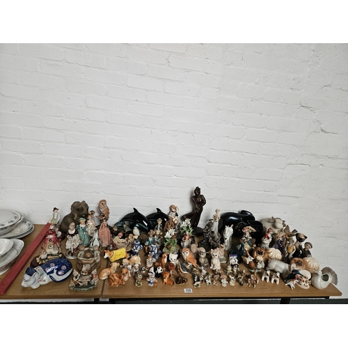 314 - A collection of ornaments to include Poole dolphins, Beswick cats, whimsies, etc