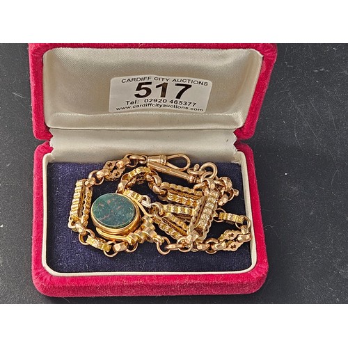 517 - A 9k gold watch chain and a 9k gold and agate swivel watch fob. Total weight 32.9 grams