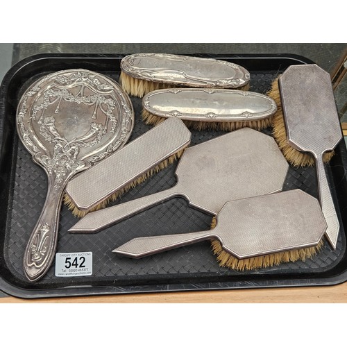 542 - A collection of silver dressing table mirrors and brushes