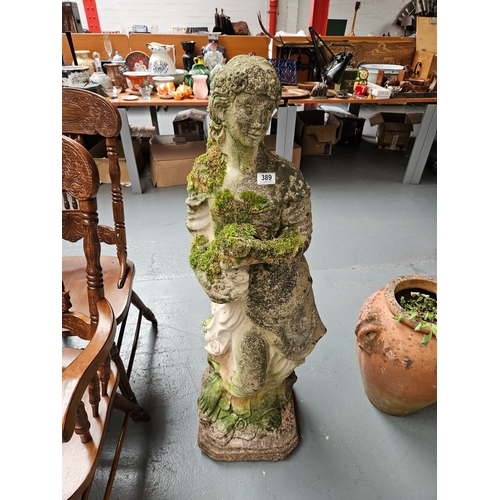 389 - A large concrete garden statue of a female figure

Height 124cm