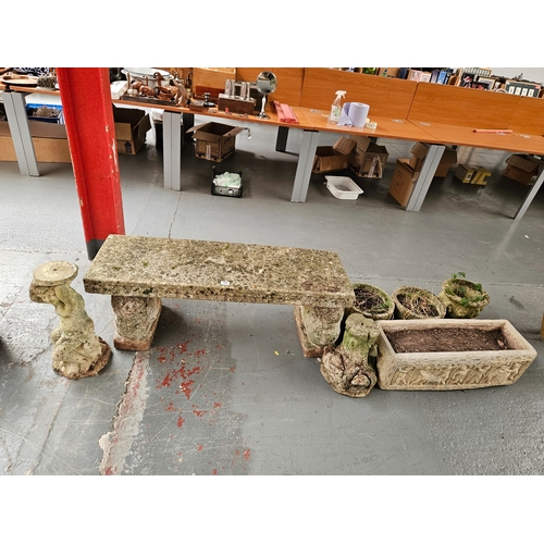 391 - A concrete garden bench together with 4 planters and 2 garden ornaments