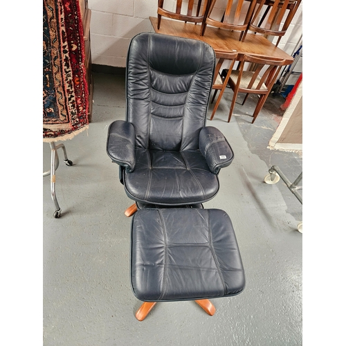 442 - A leather swivel reclining armchair with matching footstool