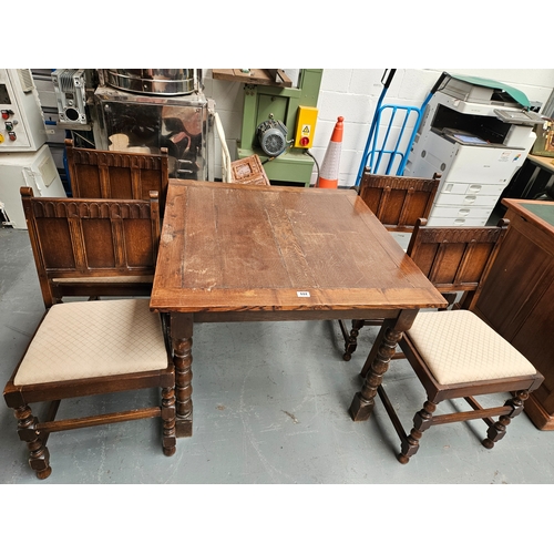 444 - An oak dining table together with 4 Ercol dining chairs