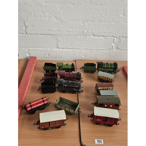 502 - Four Hornby O gauge clockwork locomotives and tenders, and eight carriages/wagons