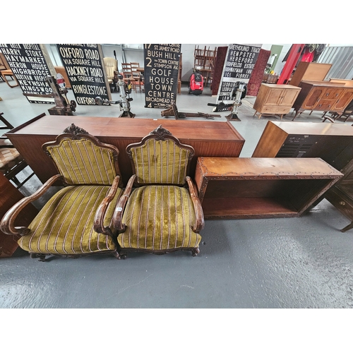 594 - A pair of upholstered armchairs together with a leatherette bound bookcase with adjustable shelf