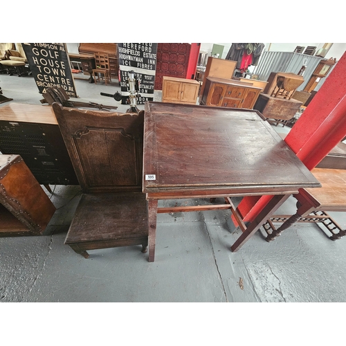 595 - An oak lambing chair together with a clerks/school lift top desk